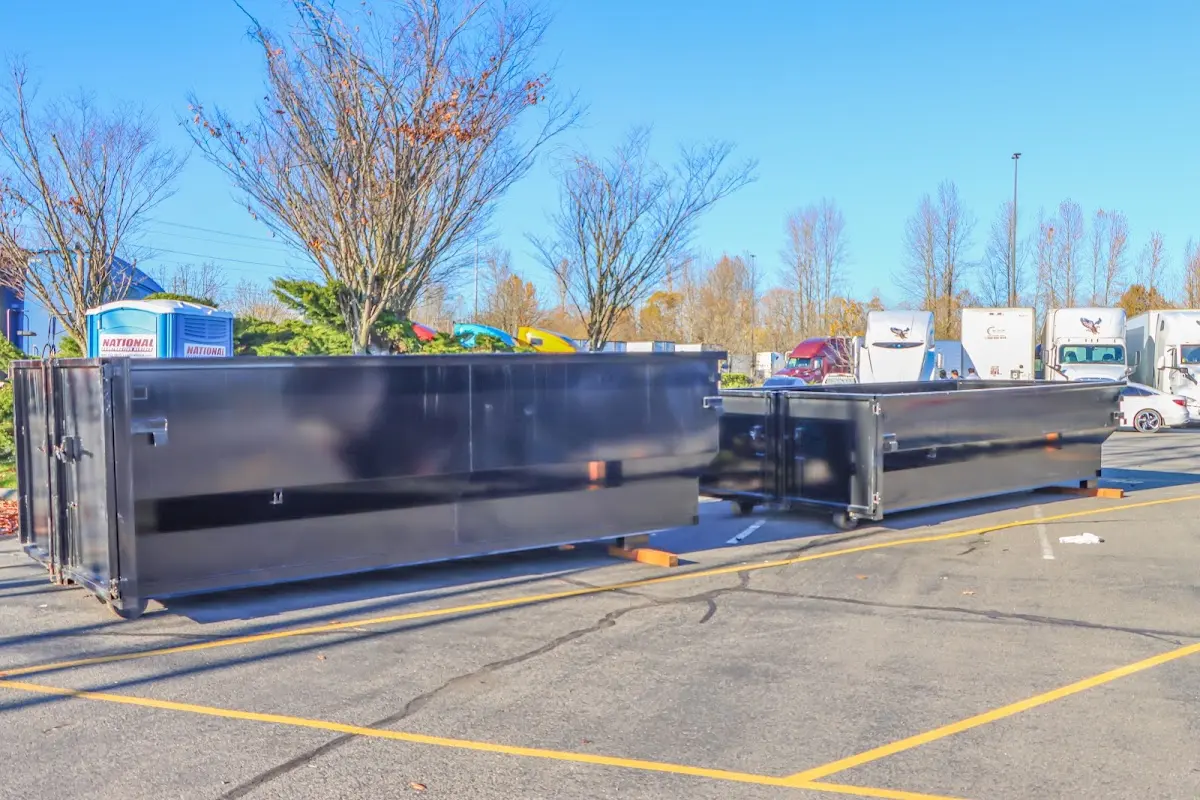 Professional dumpster rental service with roll-off container on residential driveway in Archdale